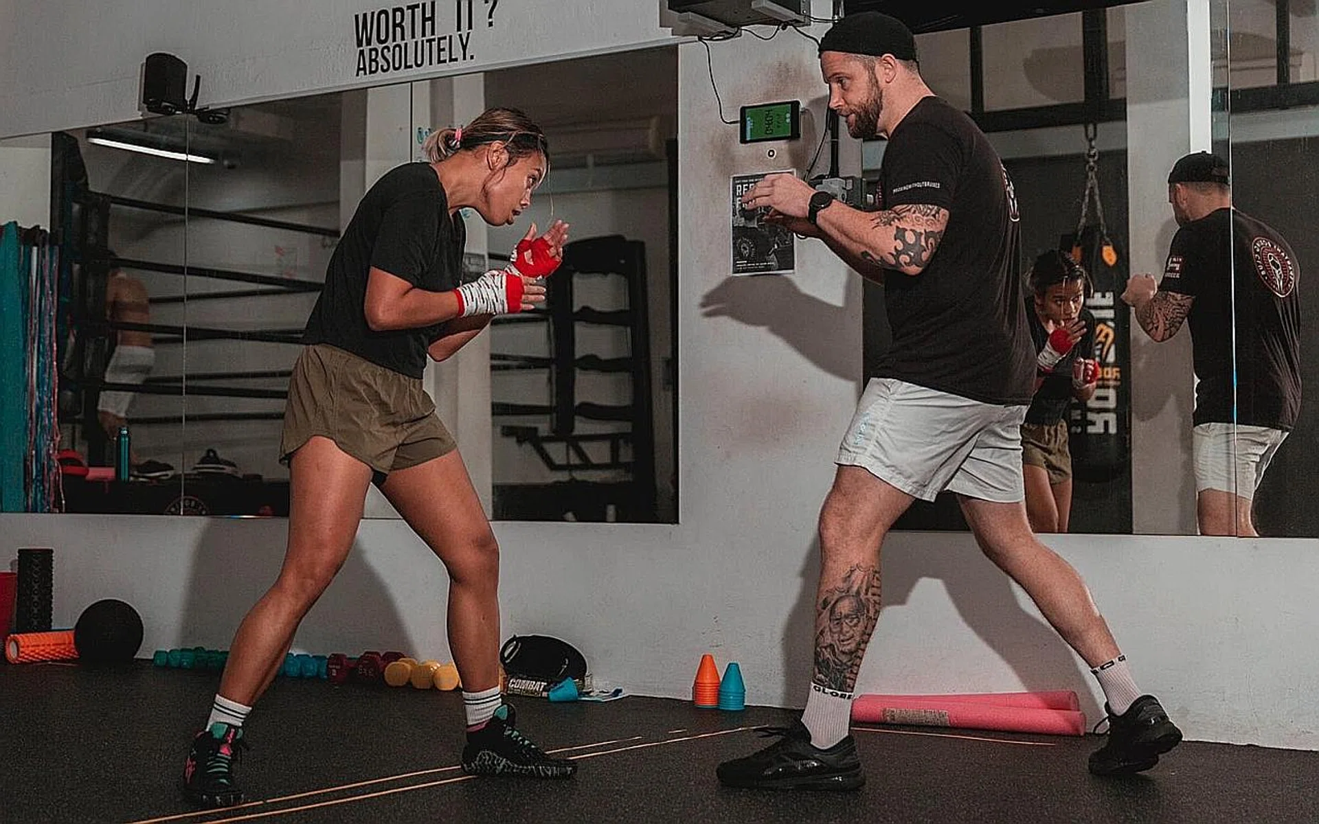 Mr Russell Harrison (in white shorts) sparring with a boxer. 