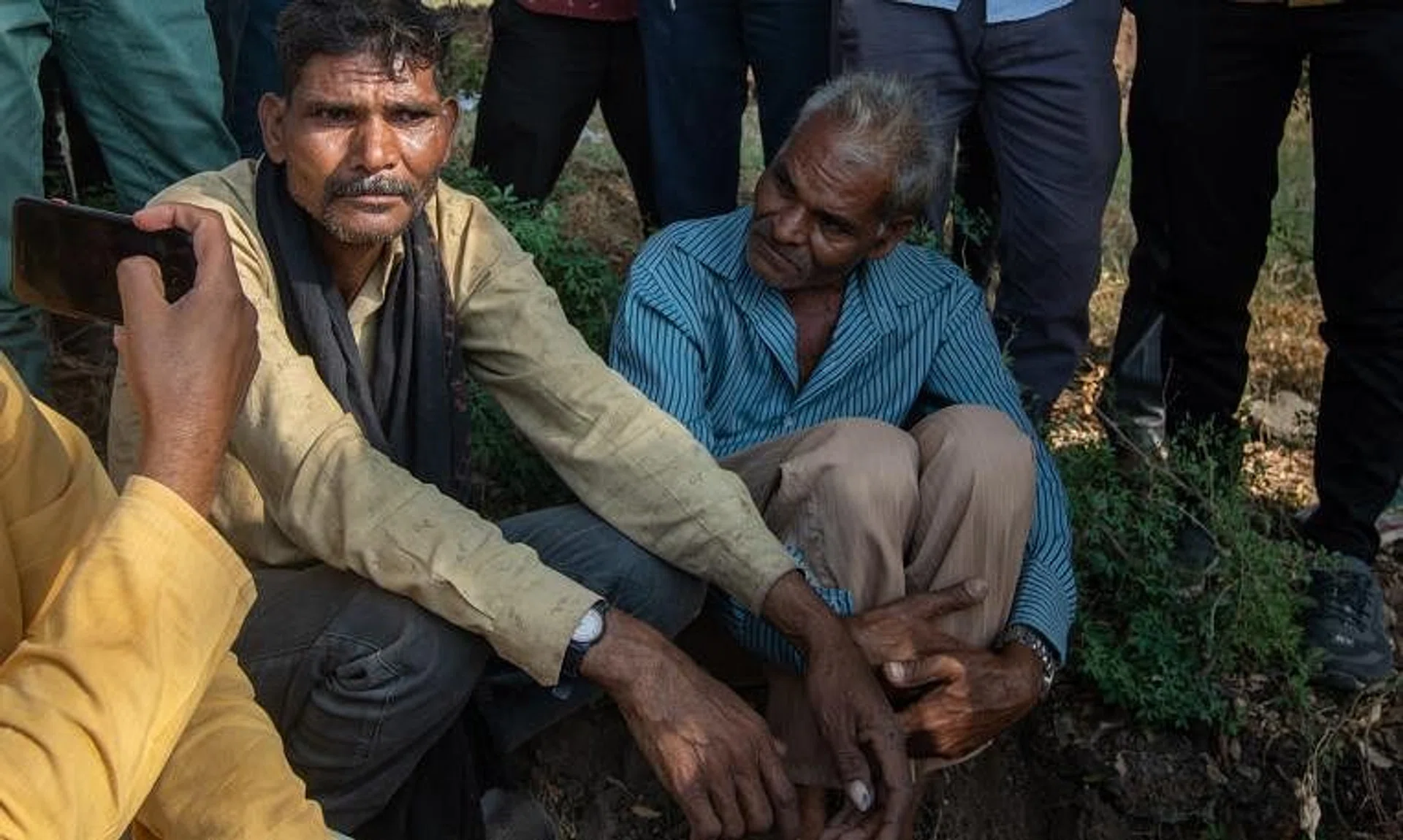The relative of a victim (left) waits for the body to be recovered during the rescue operation on Nov 1, 2022.