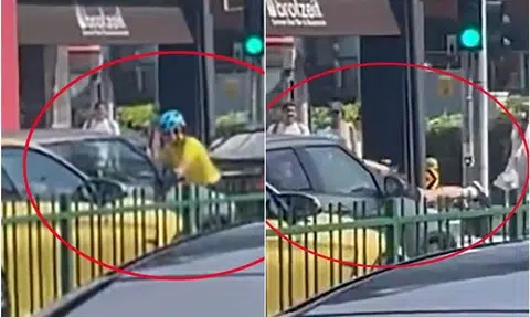Two women arrested after cyclist jumps onto moving car's bonnet