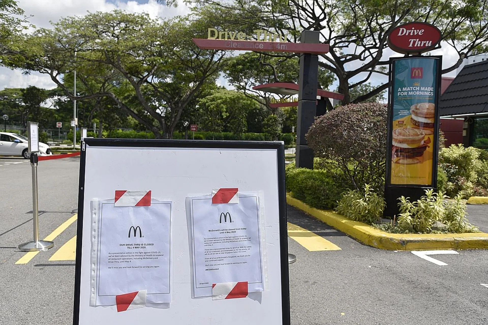 Notices of closure outside McDonald's Kallang drive-through outlet yesterday. The fast-food chain closed all branches at 11am. 