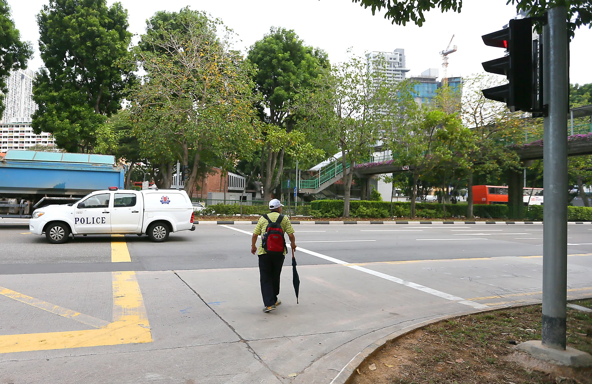TRAGIC: (Above) Pedestrians were spotted jaywalking near the spot where the fatal accident took place. 