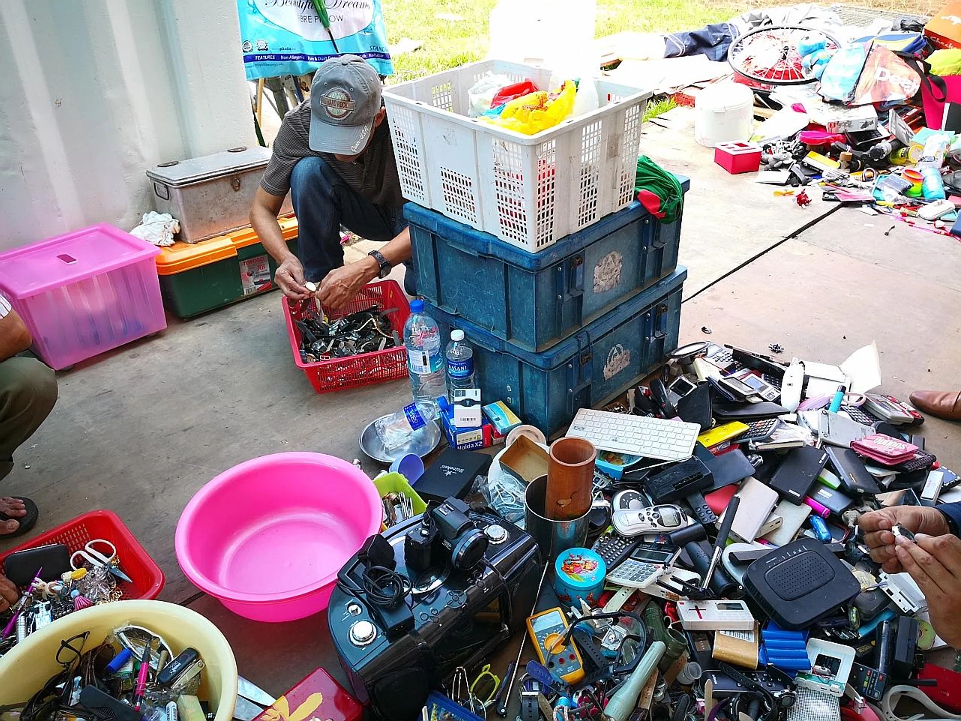 A karung guni collector going through the items he had picked up, which sometimes include valuable antiques. 