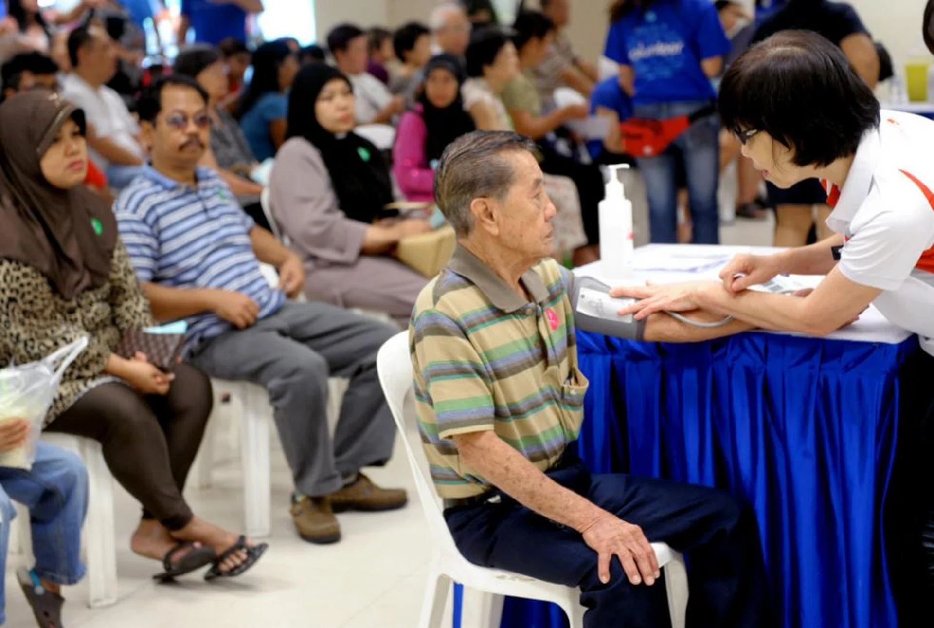Mr Chong Ming Kwang having his blood pressure checked at Jurong Medical Centre.