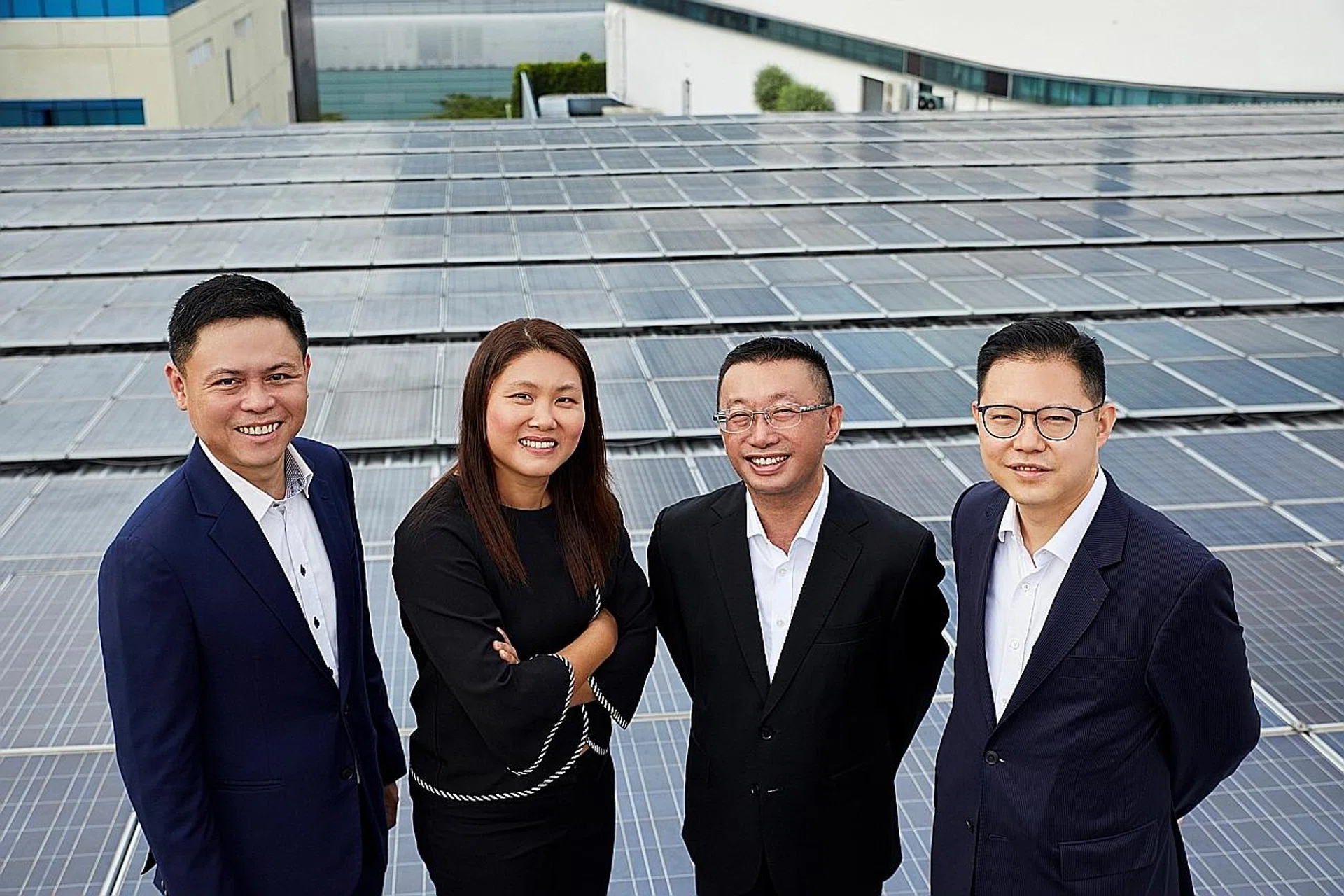 (From left) Sunseap president and executive director Lawrence Wu, Sakae Holdings chief executive and executive director Lilian Foo, Mr Choo Kee Siong, UOB's head of industry groups, group commercial banking and UOB head of group investment banking Edmund Leong at the rooftop of Sakae's headquarters in Tai Seng, where solar panels have been installed. 