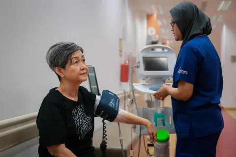 Madam Teo Soon Hwa, 66, gets her blood pressure checked before physiotherapy at National Heart Centre Singapore.
