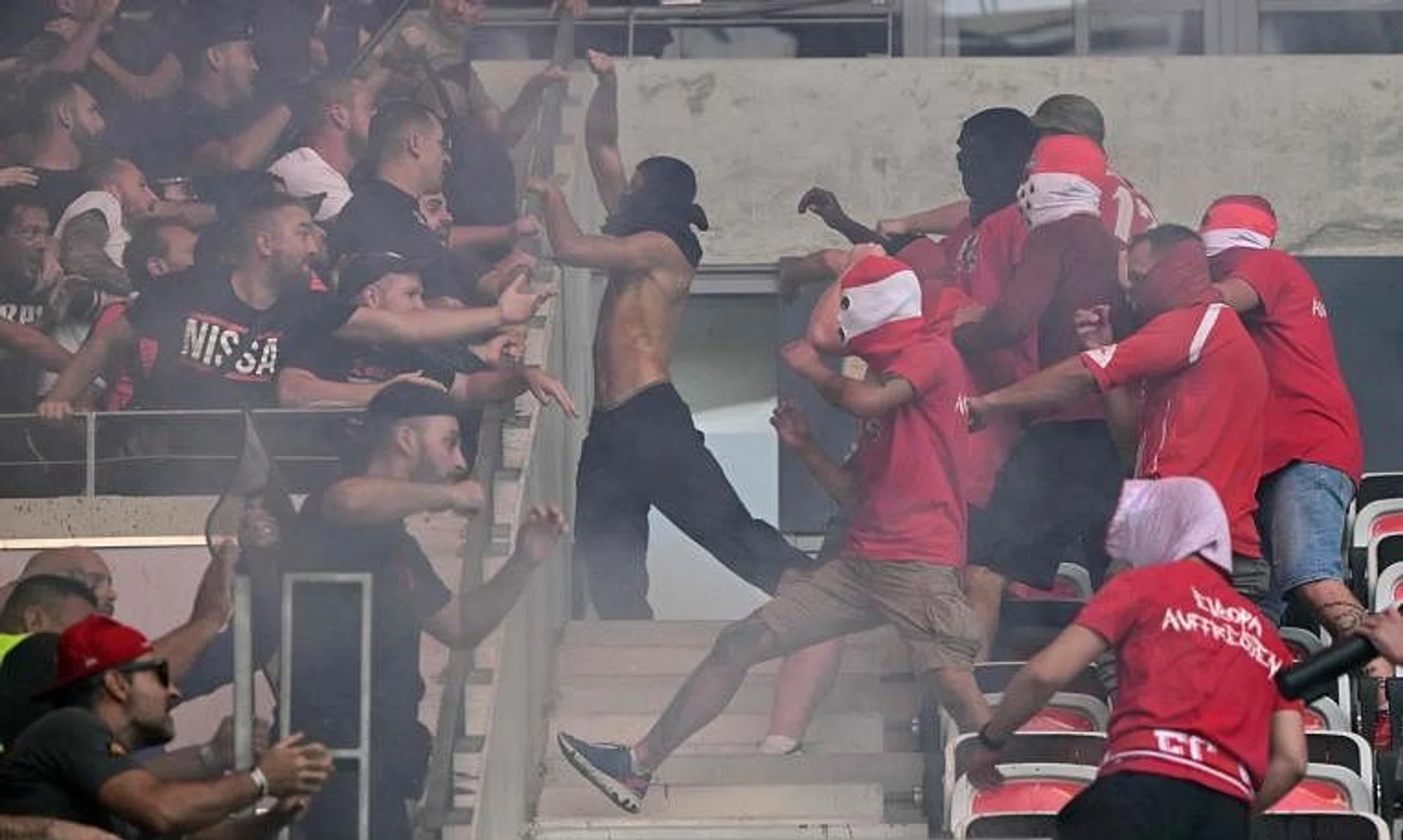 Cologne and Nice's supporters fight ahead of the football match at the Allianz Riviera in Nice on Sept 8, 2022.