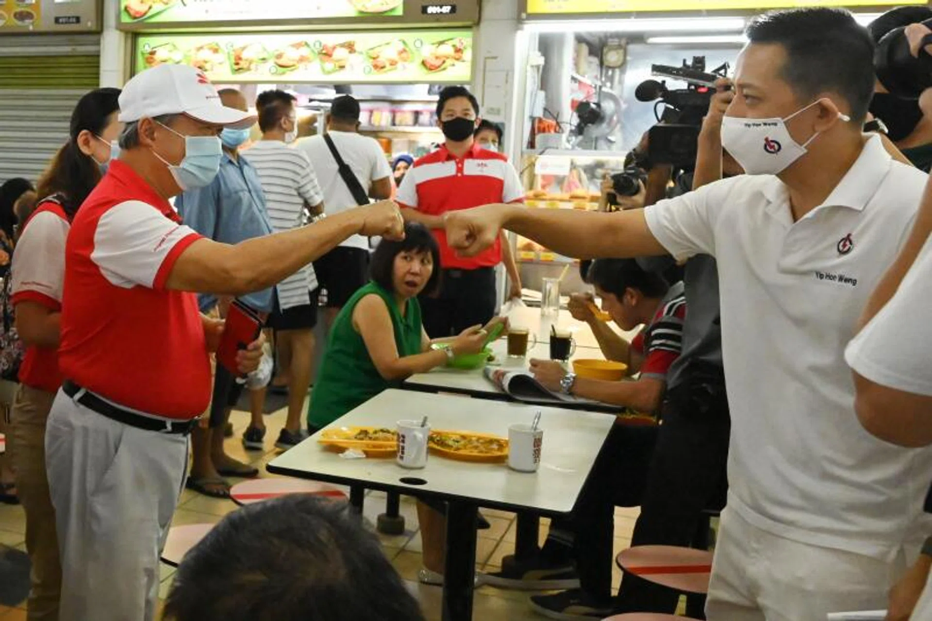 PAP's Mr Yip Hon Weng (right), who won Yio Chu Kang SMC against PSP's Kayla Low, having a fist-bump with PSP chief Tan Cheng Bock while on the campaign trail.