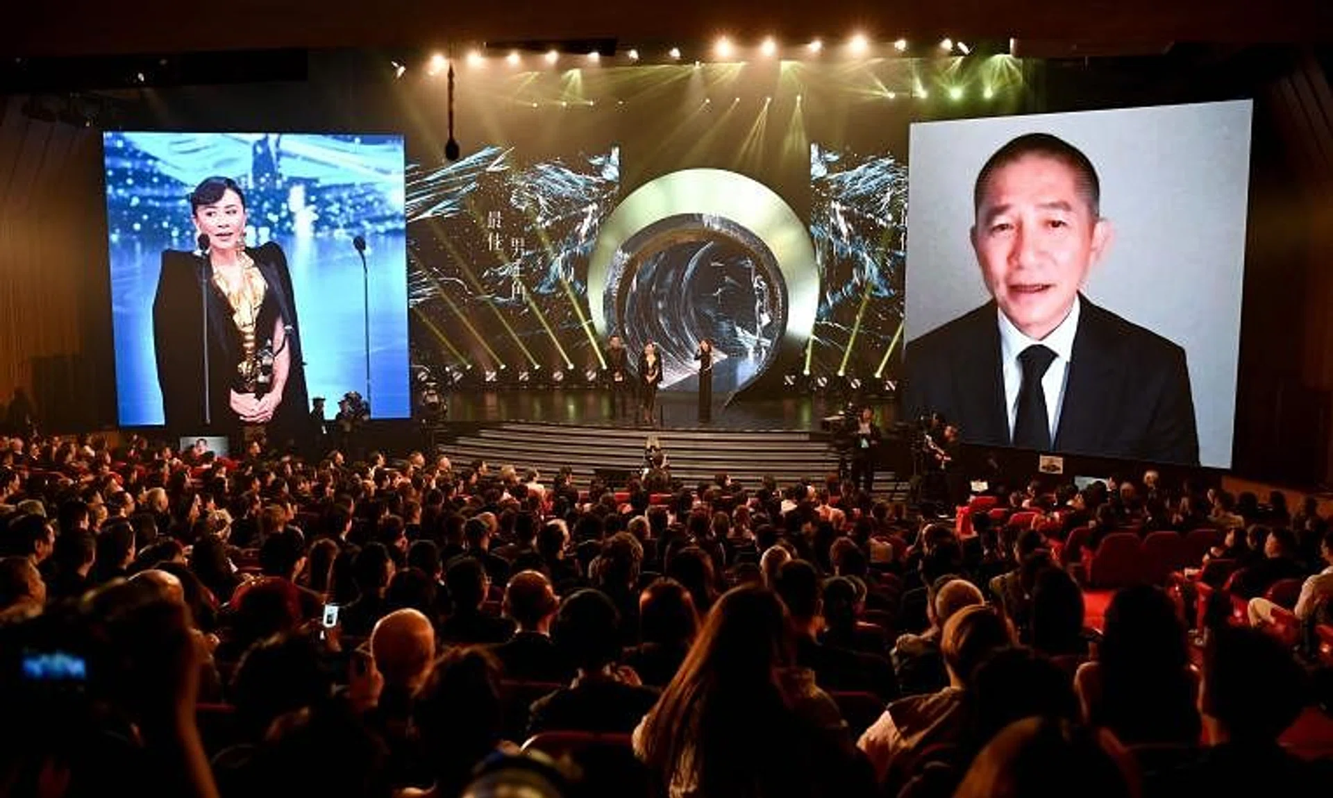 Actress Carina Lau (left) receives the Best Actor award on behalf of her husband, Tony Leung Chiu Wai (right), at the 42nd Hong Kong Film Awards on April 14.