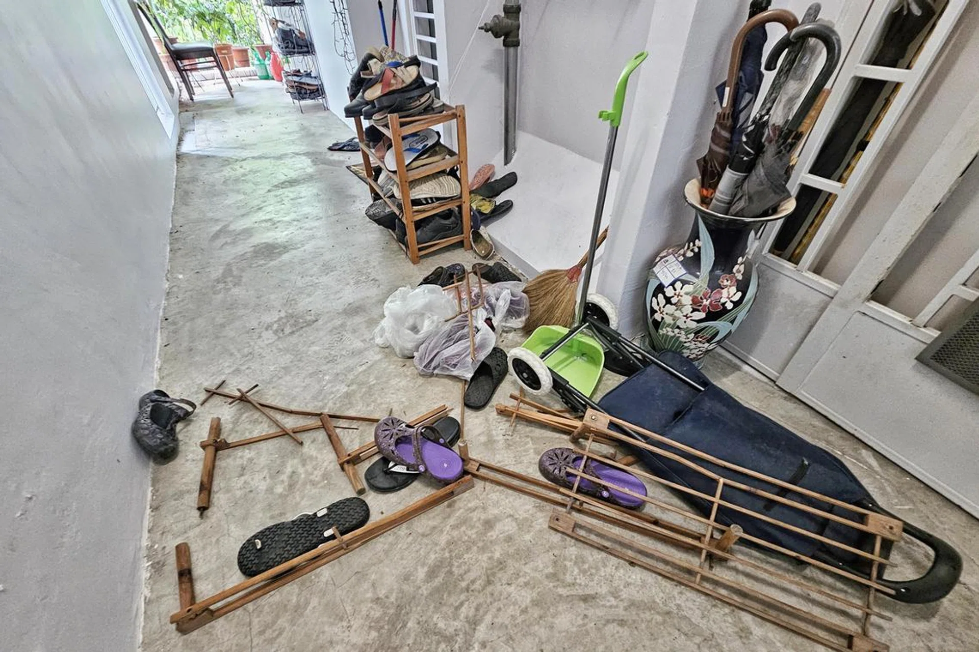 A broken shoe rack and scattered footwear outside the unit, where the fight reportedly took place.