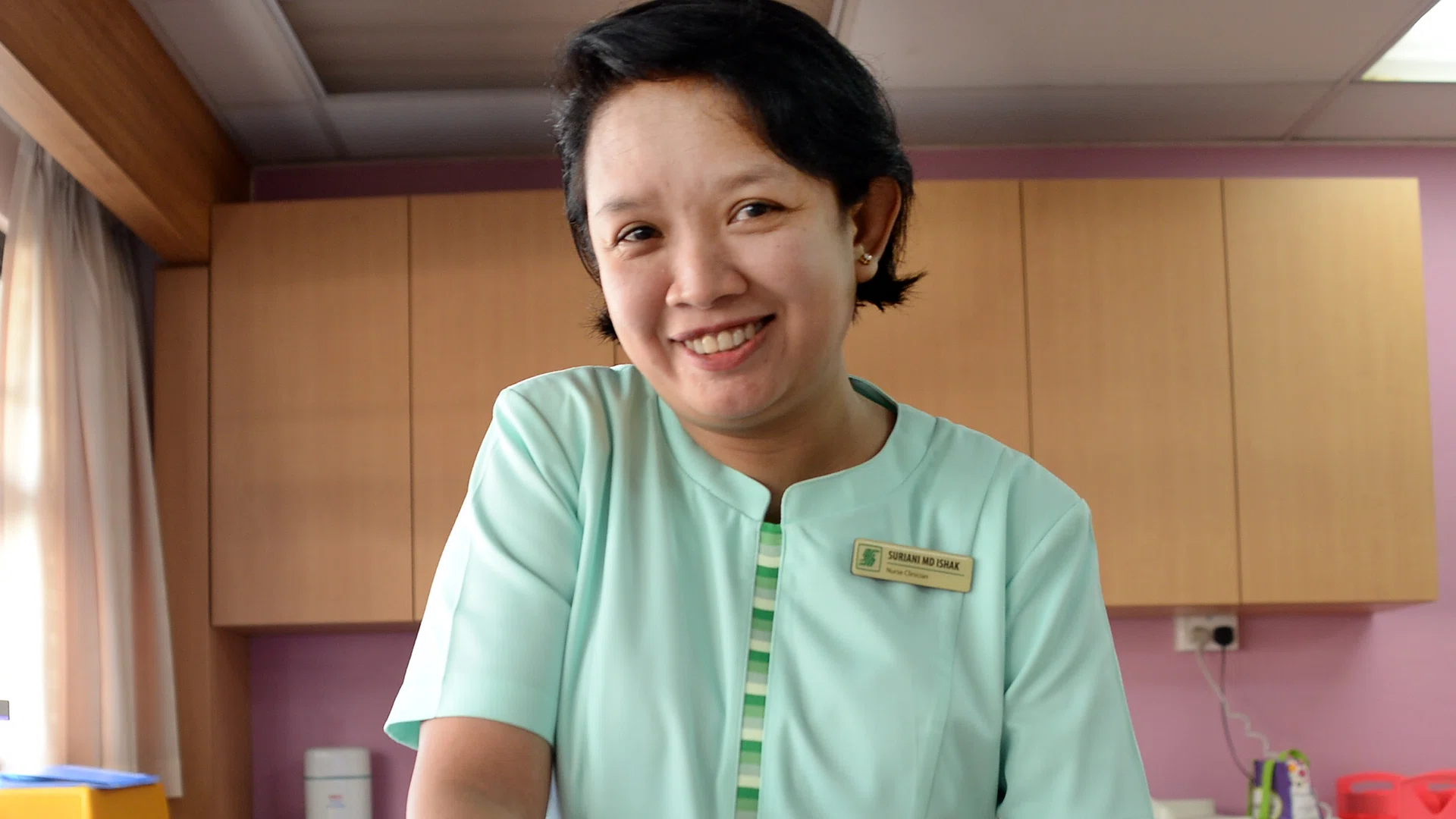 SELFLESS: Madam Suriani Muhamed Ishak took care of an abandoned baby for two years after the child's mother left Singapore.