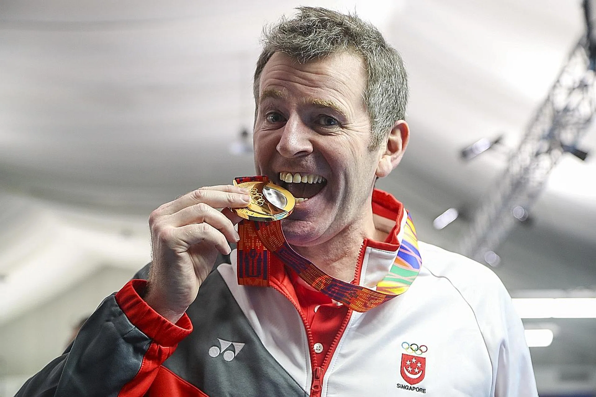 Above: Singapore's Peter Gilchrist celebrates winning his sixth consecutive SEA Games title in English billiards. 