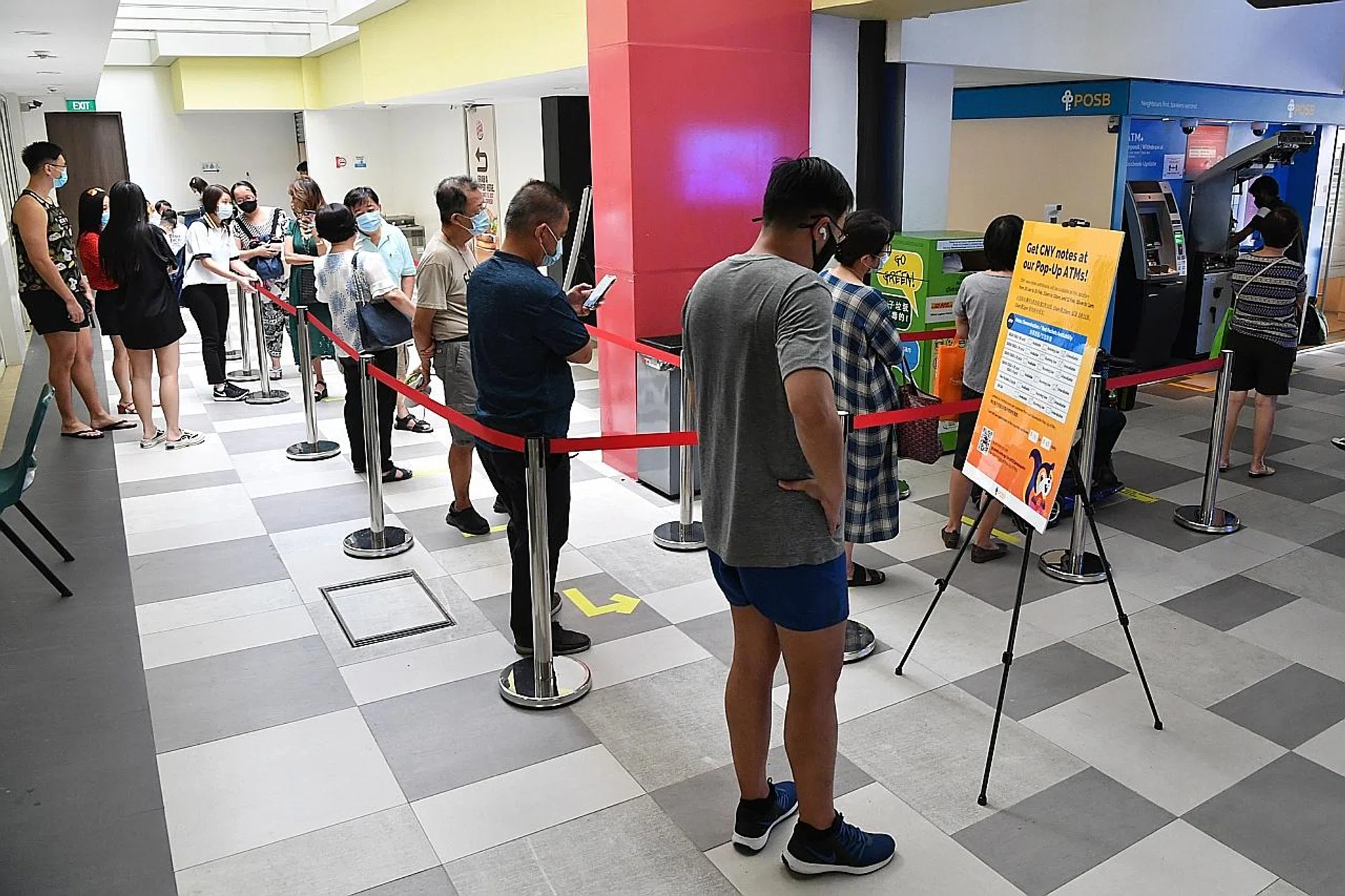 A long queue at ATMs at West Coast Community Club at around 3.30pm yesterday when one machine was being repaired. 