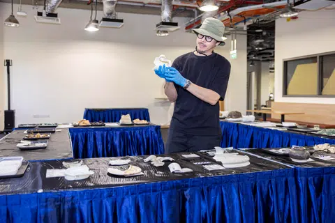 Project archaeologist Aaron Kao examining a broken mug that was retrieved from the grounds of Alexandra Hospital.