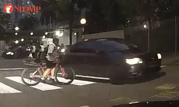Car nearly hits boy on bicycle at zebra crossing outside school