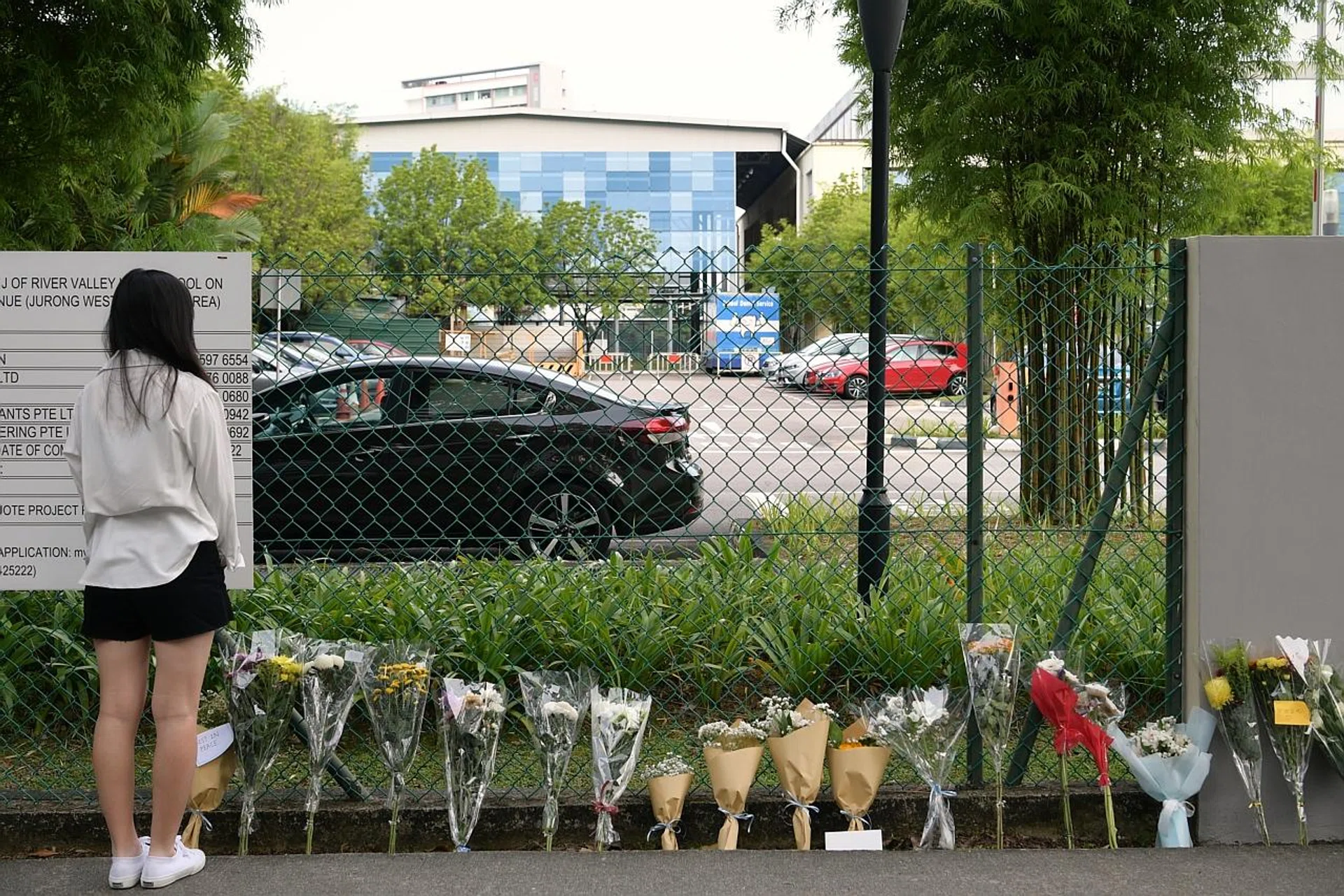 Parents, alumni and residents living nearby placed over 60 bouquets outside the school, with some placed at a wall near the main gate. Others were accompanied with plush toys, and many with notes offering encouragement and support. 