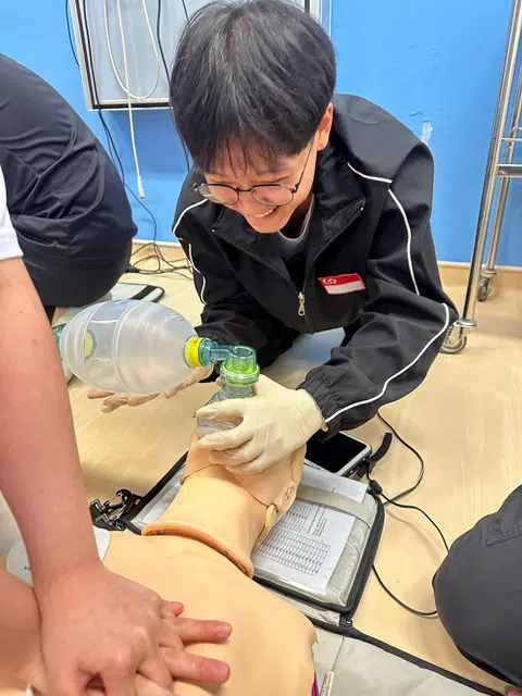 Mr Lee conducting assisted breathing to get a basic cardiac life support certification for his nursing course.