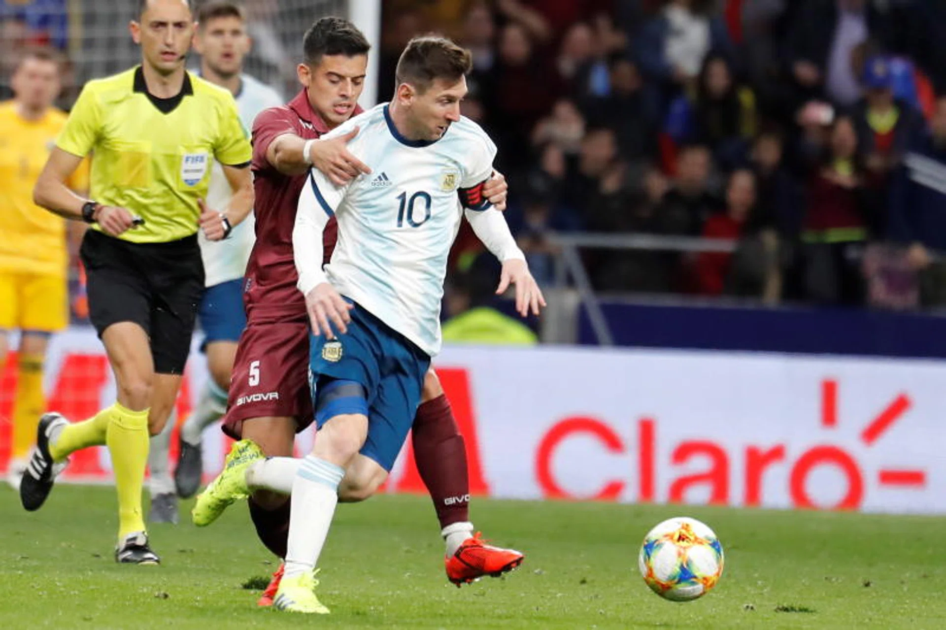 Lionel Messi trying to shrug off attention from Venezuela's Junior Moreno.