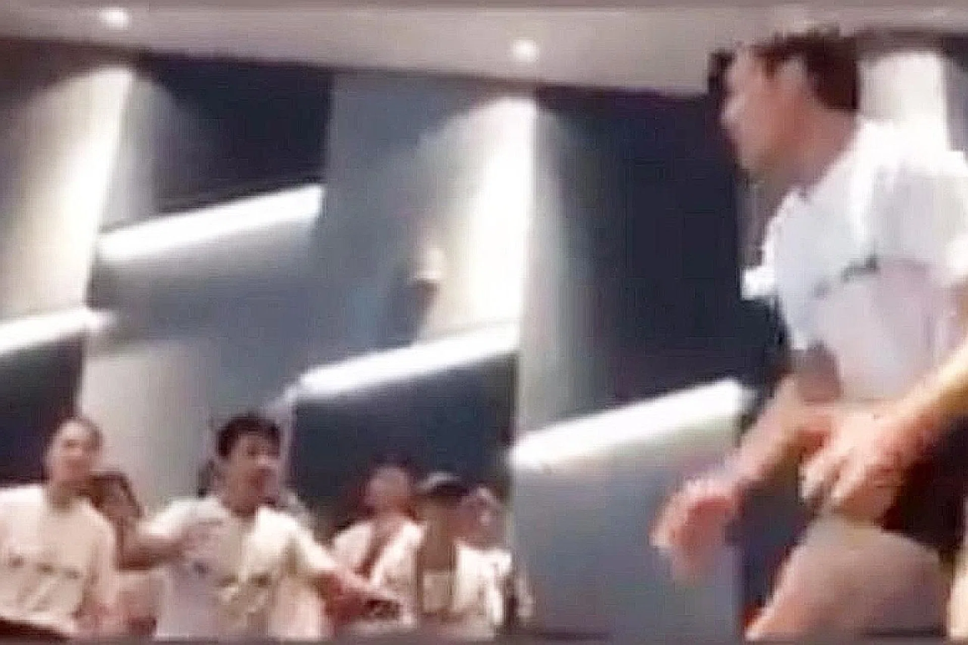 The video shows a male student leading others of both sexes in chanting while gyrating and gesturing at his genitals.