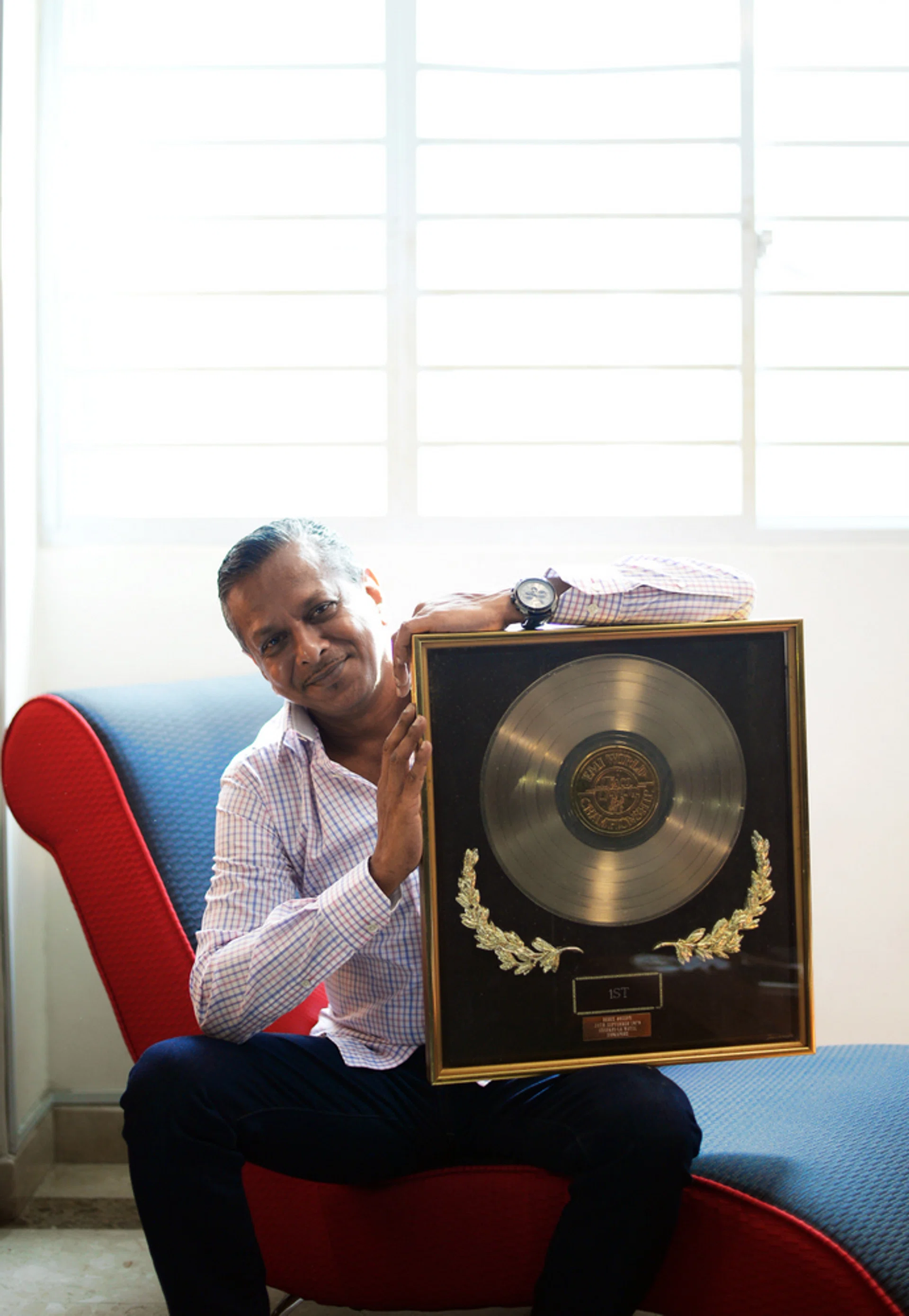 WINNER: Mr Derek Joseph with the award he received for placing first in the first Singapore Disco Dancing Competition.