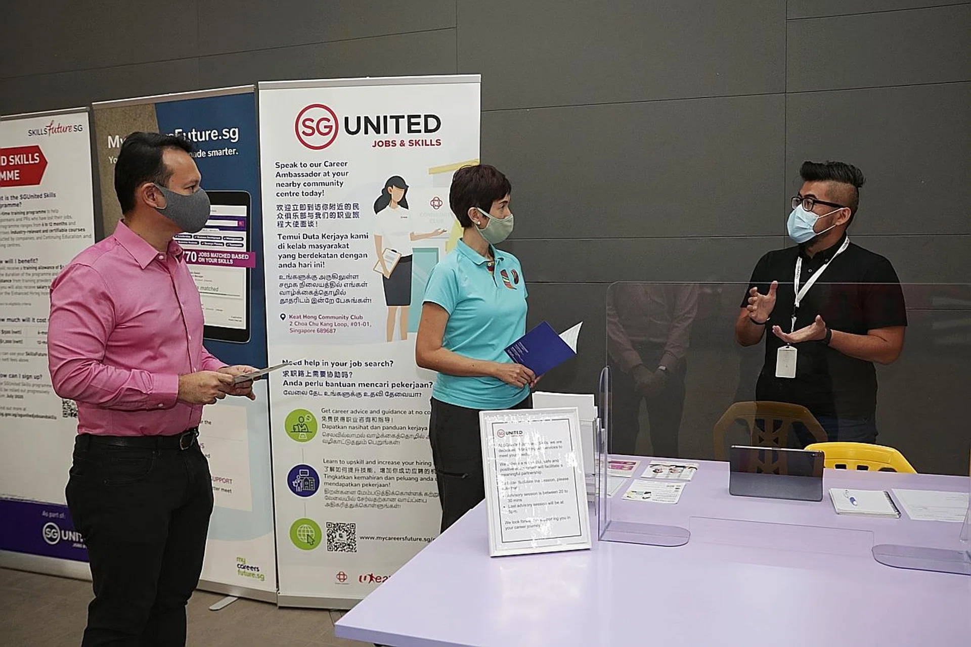 (From left) Mr Zaqy Mohamad and Mrs Josephine Teo speaking with Career Ambassador Charles Yeo at the SG United Jobs and Skills Centre in Keat Hong Community Club. 