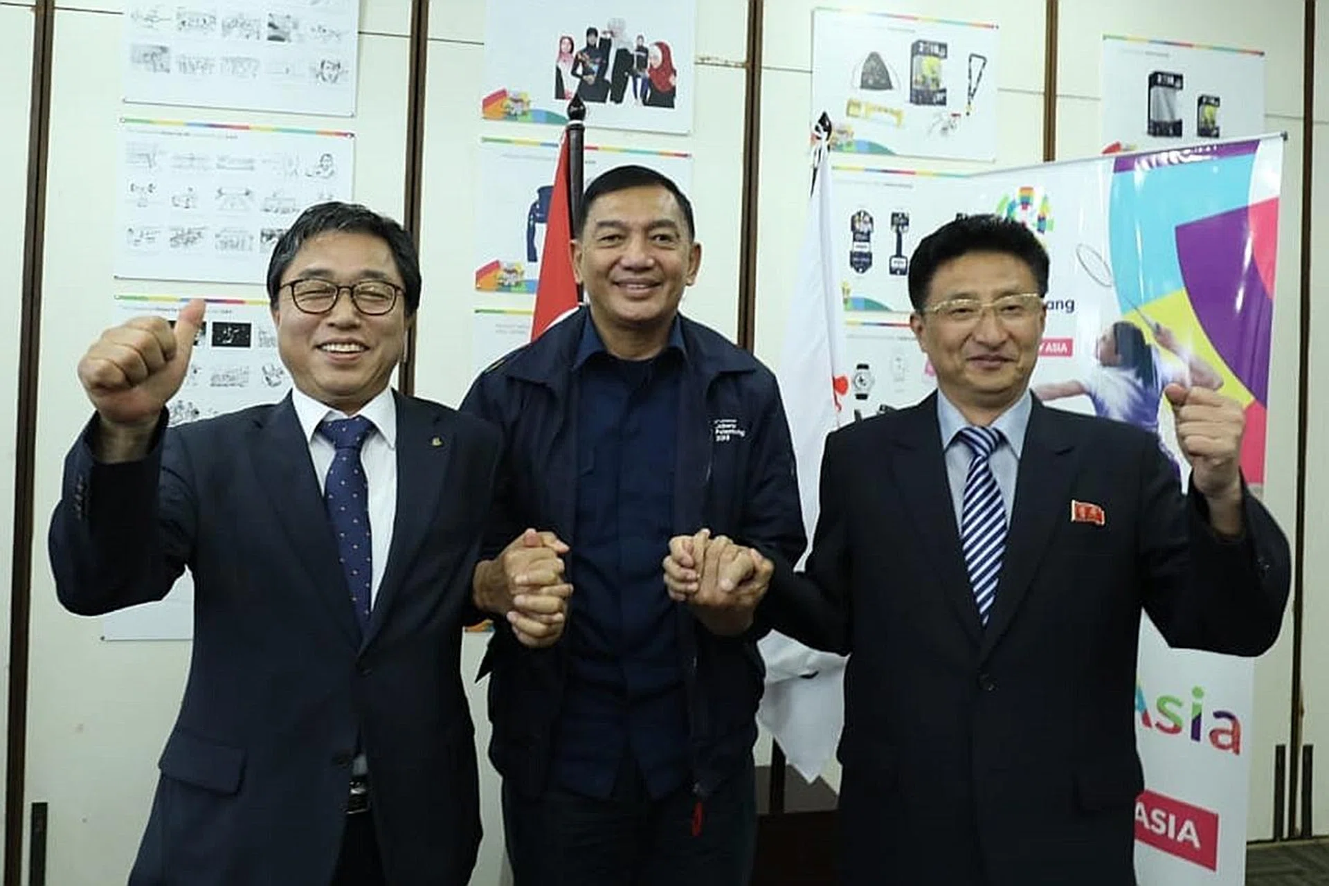 Indonesian Asian Games organising committee deputy chairman Sjafrie Sjamsoeddin (centre) posing with North (right) and South Korean (left) representatives last month.