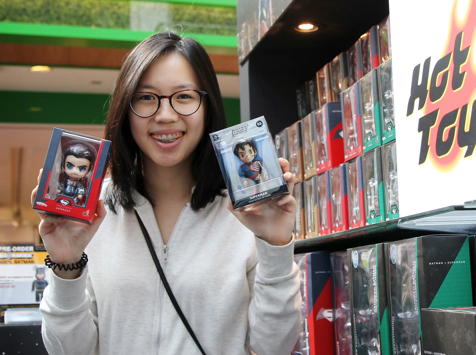 HER TOY BOYS: (above) Miss Nico Wong bought two Superman figurines at Action City’s booth at the Hero Toys Fair.