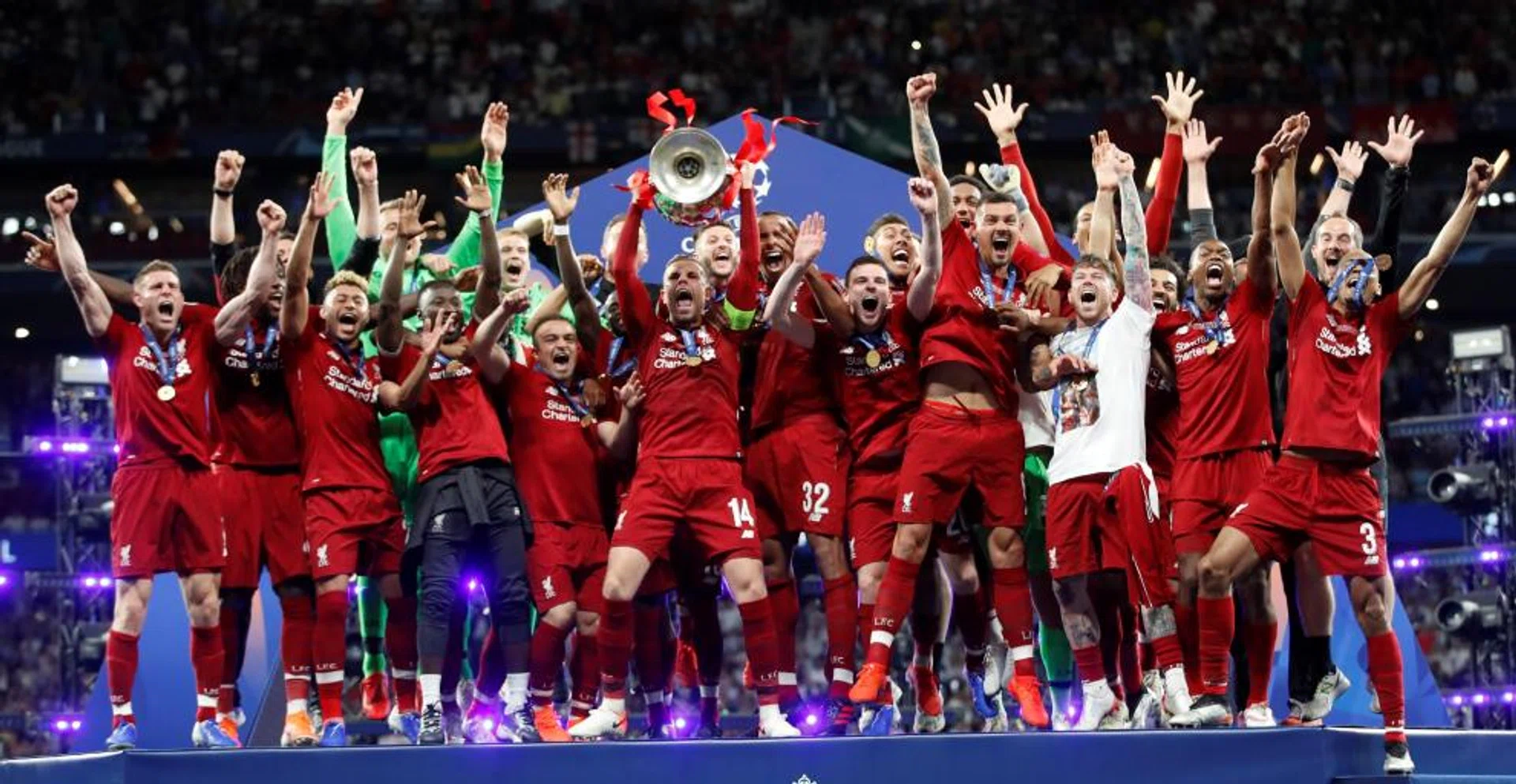 A buoyant Liverpool squad celebrate after winning the Champions League.