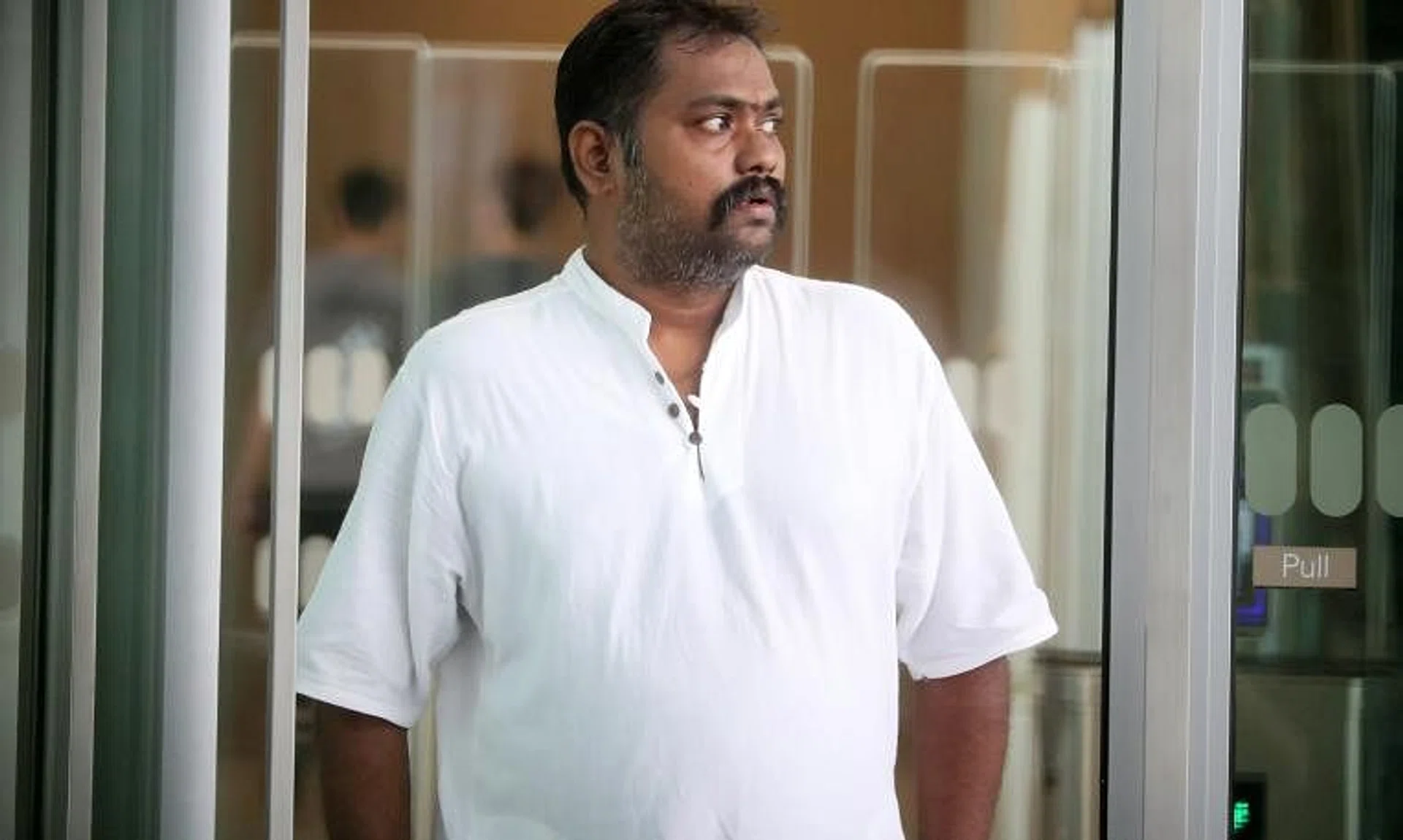 Logeswaran Mohandas at the State Courts in April 2023. He had impersonated his brother on nine occasions and an acquaintance on eight occasions.