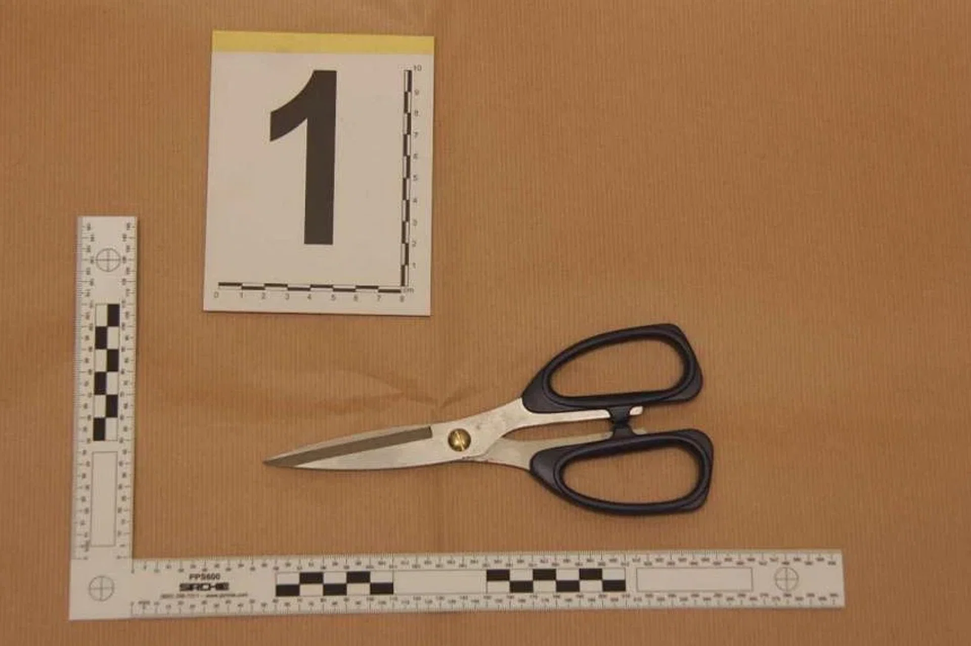 The man punched one of the victims several times and hit another man on the right shoulder with a pair of scissors.  

