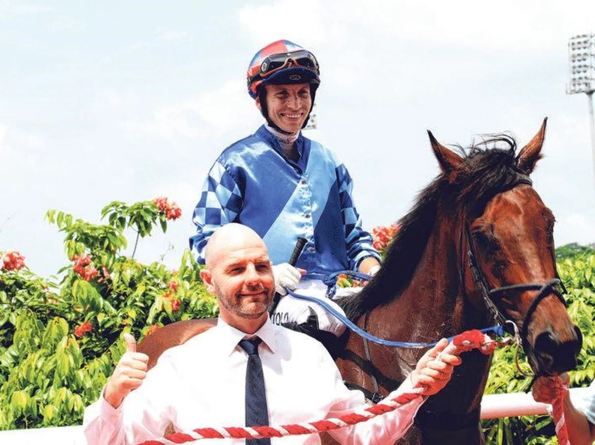 Trainer Tim Fitzsimmons showing the thumbs-up as Ravalli (Ryan Curatolo) pays his first visit to the Kranji winner's enclosure on June 16.