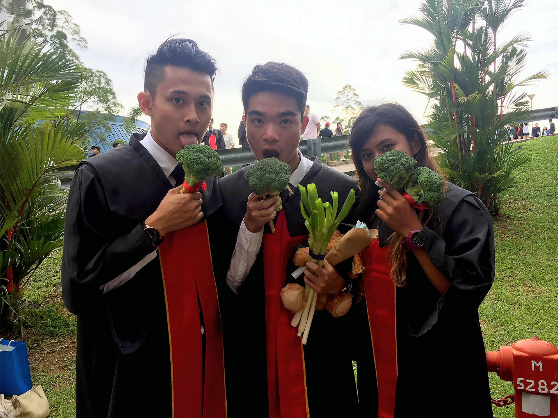 Mr Daryl Yeo Kang He (centre) gifted his classmates broccoli during their graduation.