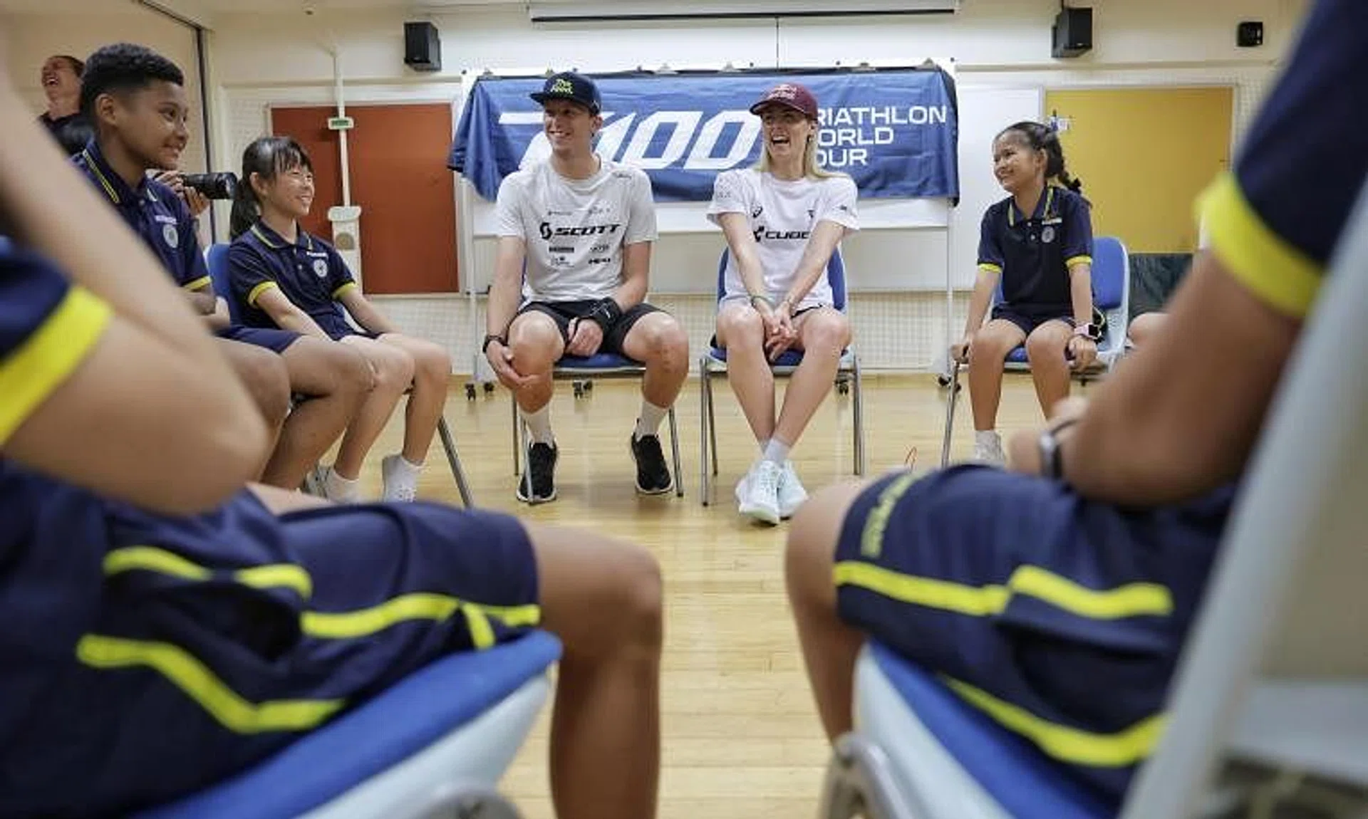 Reigning Ironman world champion Lucy Charles-Barclay and Miami T100 men's champion Magnus Ditlev speaking about nutrition with pupils at Sembawang Primary School.