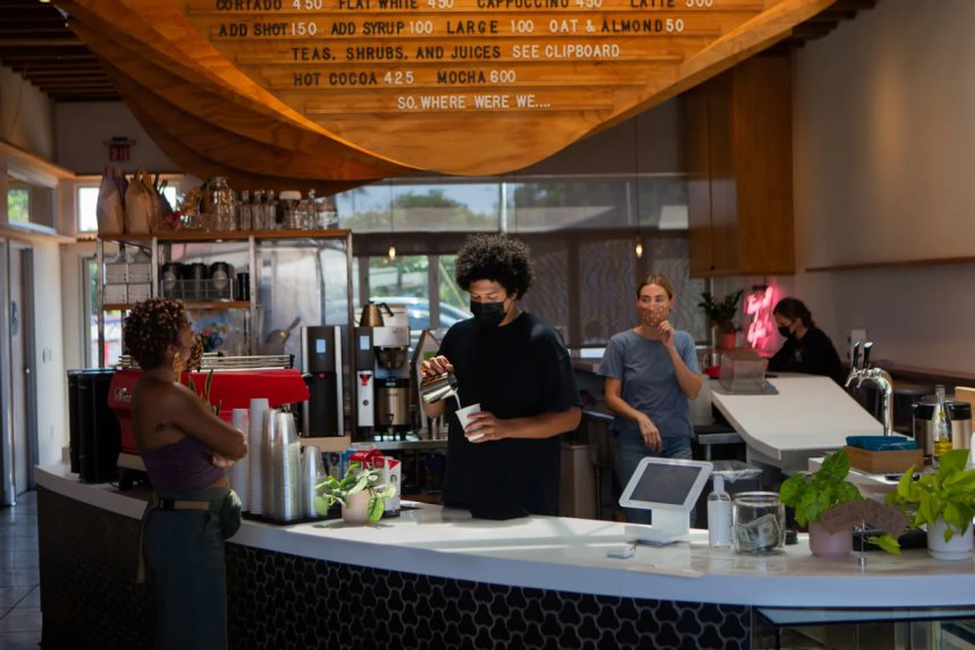 Staff and customers wear face masks at Dinosaur Coffee in Los Angeles on July 27, 2021. The mandate will last a month.