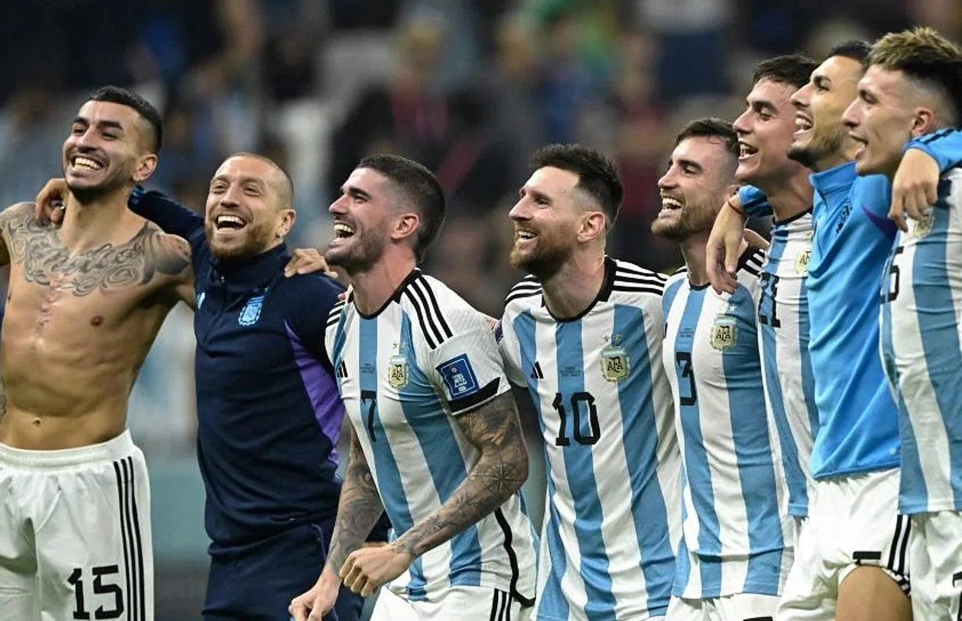 Argentina's Angel Correa, Alejandro Gomez, Rodrigo De Paul, Lionel Messi, Nicolas Tagliafico, Paulo Dybala, Leandro Paredes and Lisandro Martinez celebrate with supporters after defeating Croatia.
