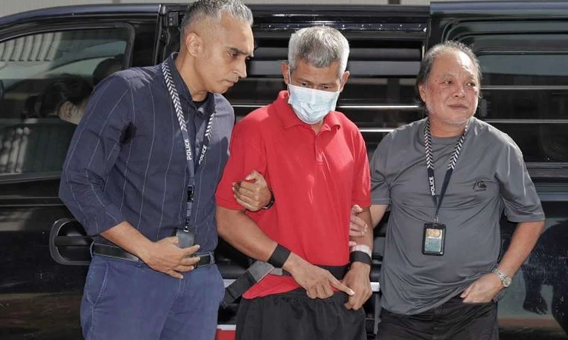 Police taking Affendi Yusoff (centre), who allegedly murdered a 35-year-old man on July 27, back to the crime scene at Block 803, Yishun Ring Road, on Aug 6, 2024. 