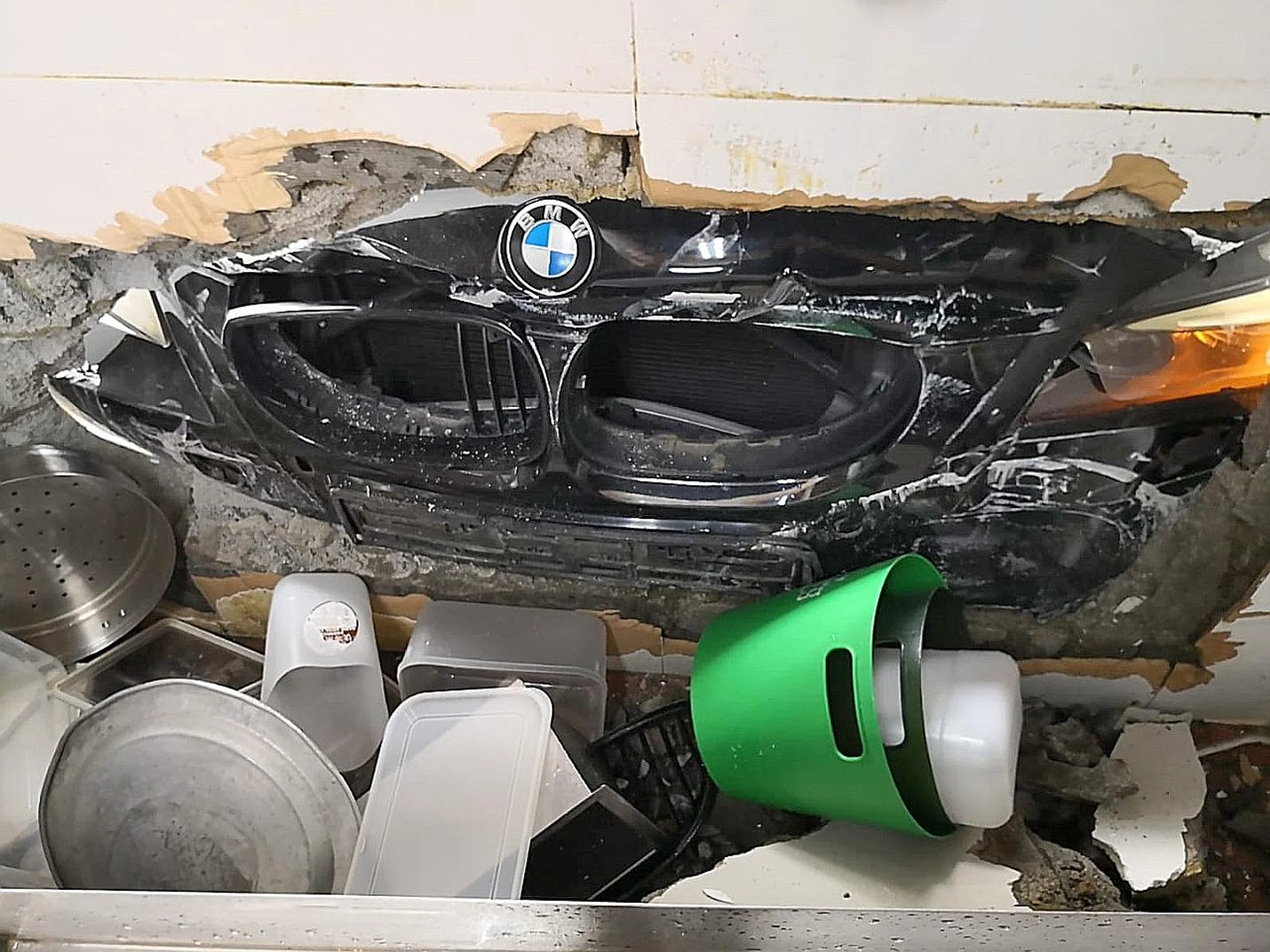 The car smashed a hole in the wall of a coffee shop. 