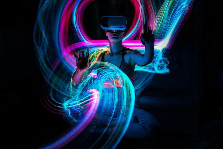 Metaverse digital Avatar, Metaverse Presence, digital technology, cyber world, virtual reality, futuristic lifestyle. Woman in VR glasses playing AR augmented reality NFT game with neon blur lines; Shutterstock ID 2106145790; purchase_order: Arnaud Pourpoint; job: ; client: ETX Studio / Daily Up; other: