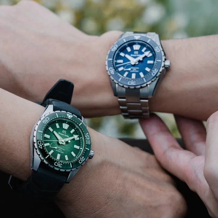 The Grand Seiko Spring Drive U.F.A. Ushio 300 Diver in blue (SLGB023) and green (SLGB025) worn on wrists, showcasing the compact 40.8mm High-Intensity Titanium cases, textured gradient Ushio dials, ceramic bezels and balanced proportions designed for comfortable everyday wear.