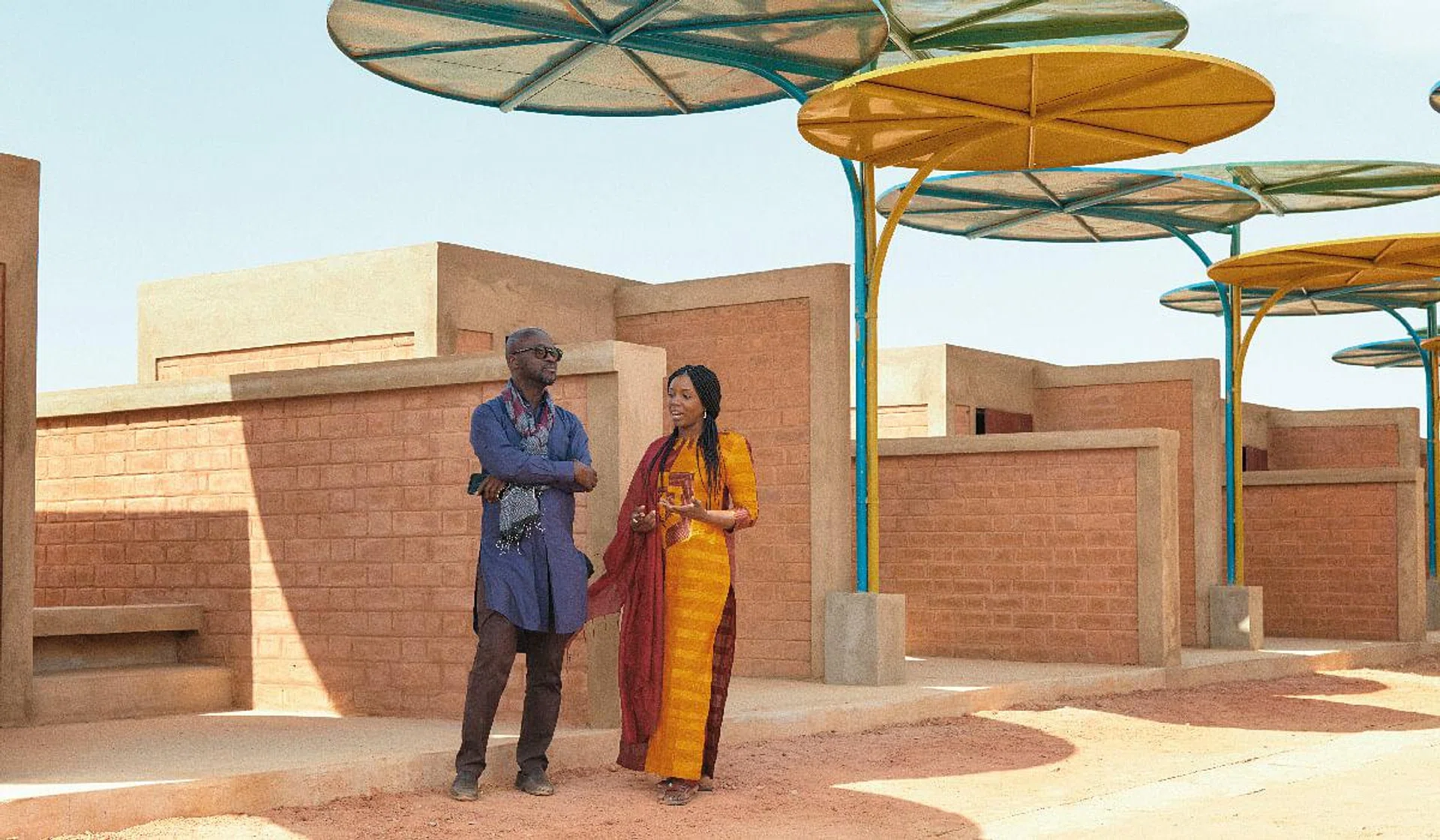 Architects David Adjaye and Mariam Kamara at a Nigerian market designed by the latter’s practice.