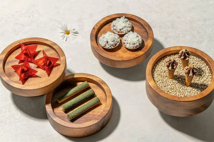 (from left to right) Watermelon with goat's cheese and pistachio, Black trumpet cigar, Hokkaido scallop with sea urchin custard in a potato tart shell, and the Foie gras cornetto