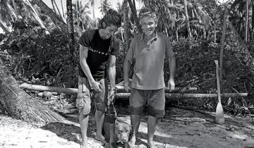 Gauthier Toulemonde (left) with Docastaway founder Alvaro Cerezo and the dog he borrowed to drive away rats and snakes.