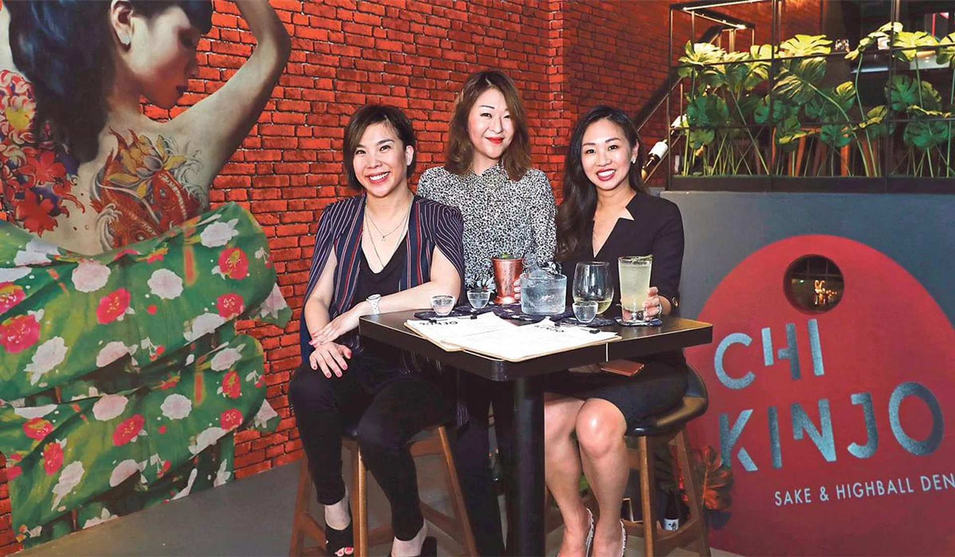Sisters Sandra (centre) and Sharon (right) Sim, with their business partner Tay Eu-Yen, at their new sushi and highball bar Chi Kinjo.