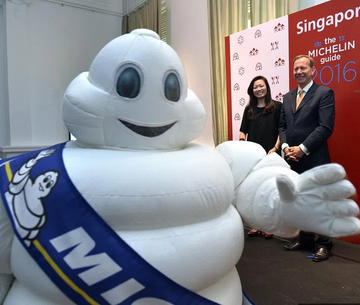 (Left to Right) Ms Melissa Ow, deputy chief executive of the Singapore Tourism Board; Mr Michael Ellis of Michelin Guides International; and Ms Michelle Ling, director of Robert Parker Wine Advocate, at the press conference to announce Michelin Guides bilingual Singapore edition which will be launched in 2016. Michelin mascot Bibendum is in the foreground.