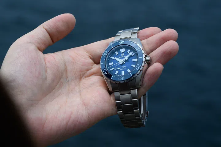 The Grand Seiko Spring Drive U.F.A. Ushio 300 Diver SLGB023 featuring a 40.8mm High-Intensity Titanium case, deep blue gradient Ushio-pattern dial inspired by ocean tides, unidirectional ceramic bezel, luminous Evolution 9 hands and indexes, and matching titanium bracelet.