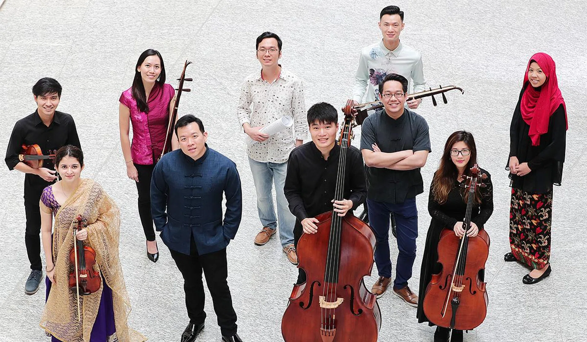 Front row, from left: Sharanya on the Indian violin, conductor Adrian Chiang, Edmund Song on the double bass, conductor Dedric Wong and Melissa Ong on the cello. Back row, from left: Gabriel Lee on the violin, Rozie Hoong on the erhu, composer Wang Chenwei, Fred Chan on the erhu and composer Syafiqah 'Adha Sallehin