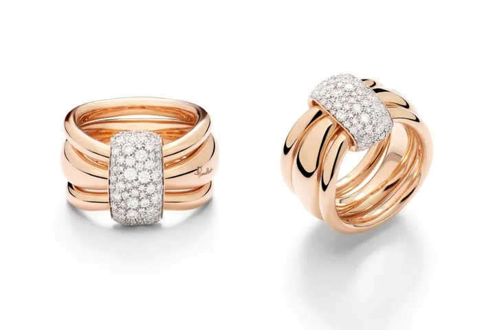 Three independent rings are wrapped by a diamond-paved central link in this Pomellato Together design