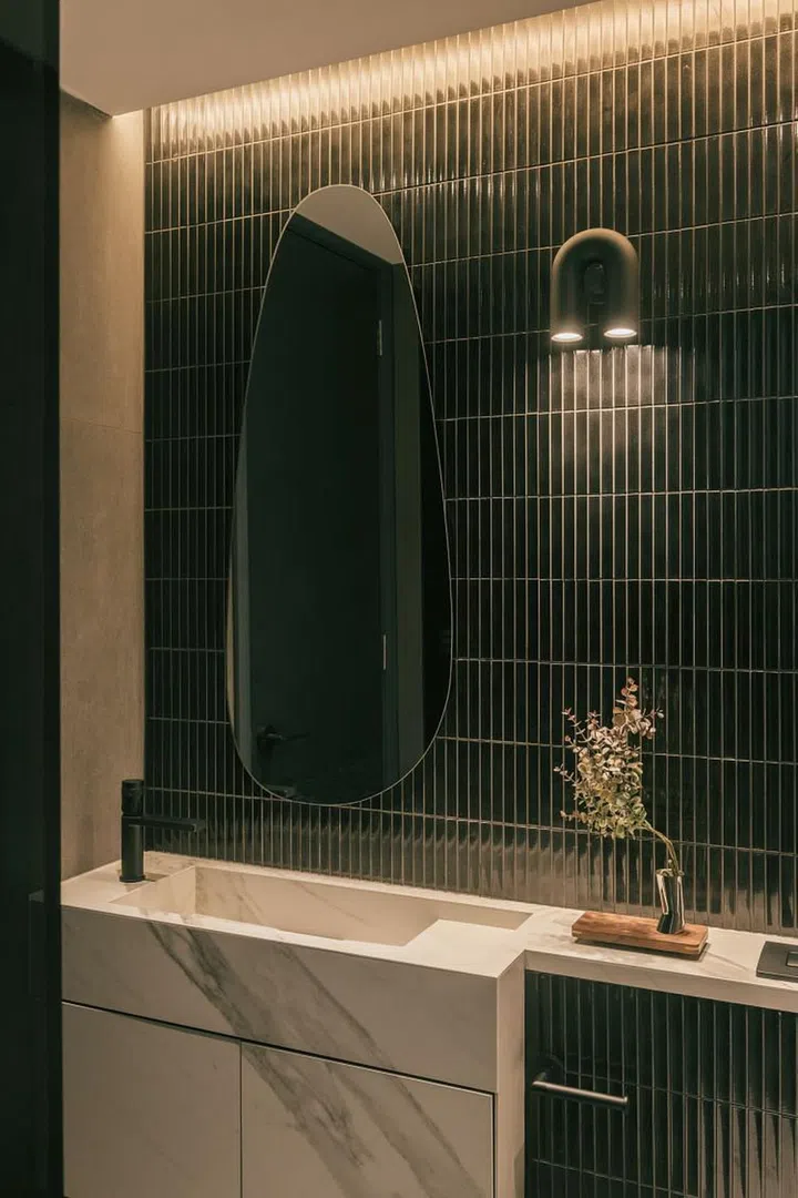 In the son's bathroom, "KitKat" tiles in a glossy black finish are used. The designers also created an integrated sink, as the space is very compact. (Photo: Finbarr Fallon, courtesy of Parenthesis Studio)