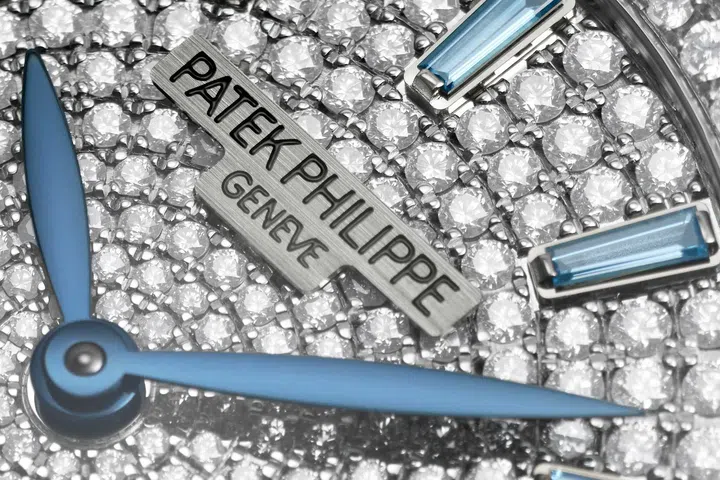 Close-up of the Patek Philippe Gondolo Ladies First Joaillerie Ref. 7043/250G-001, showing its diamond-set dial and case, blue topaz hour markers and blue hands.