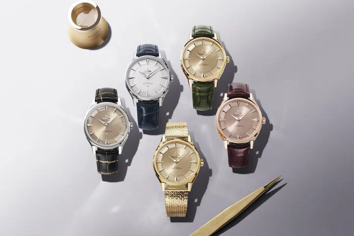 A selection of Omega Constellation Observatory watches displayed together, featuring different shades of gold cases and matching integrated bracelets.