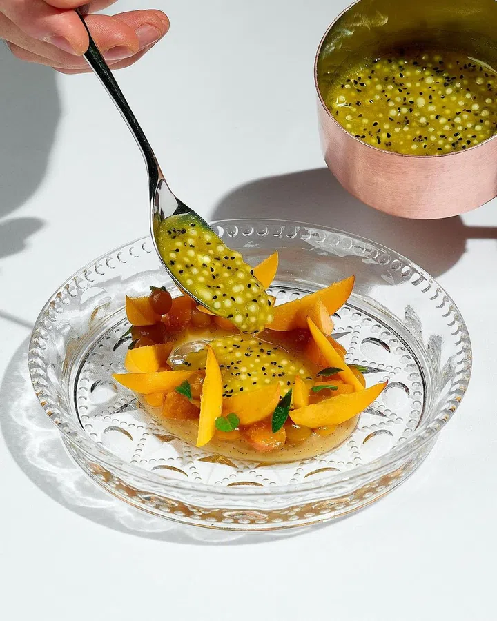 A dessert from the summer menu: Milchreis (German rice pudding) paired with peaches and passionfruit. (Photo: IGNIV Bangkok)
